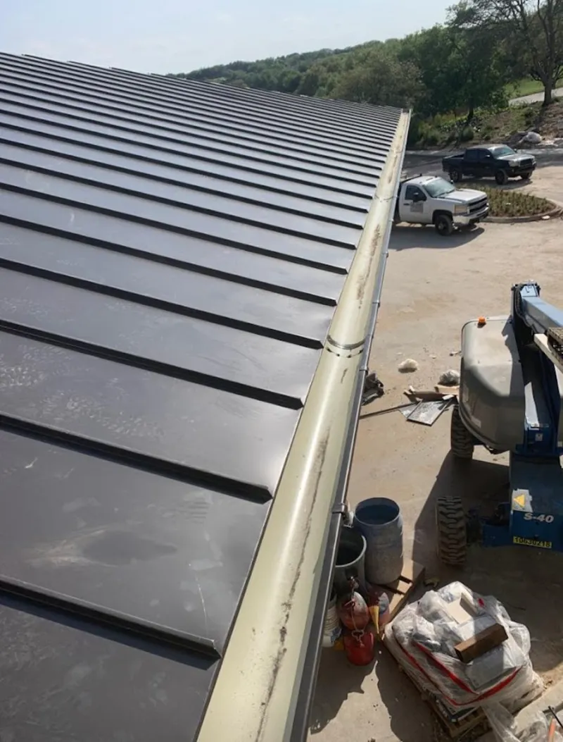 Standing seam panel and gutter detail on a metal roofing jobsite in Millbrae